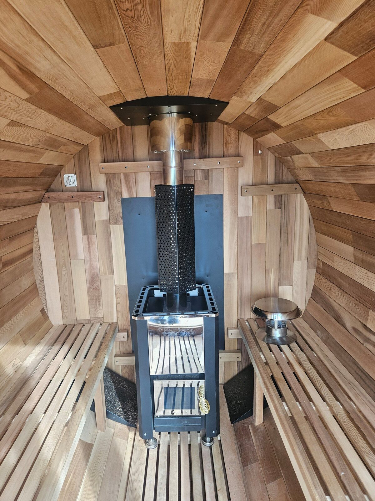 Wooden barrel sauna interior built by A1M Construction